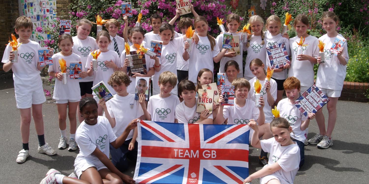 Children holding flag & trophy