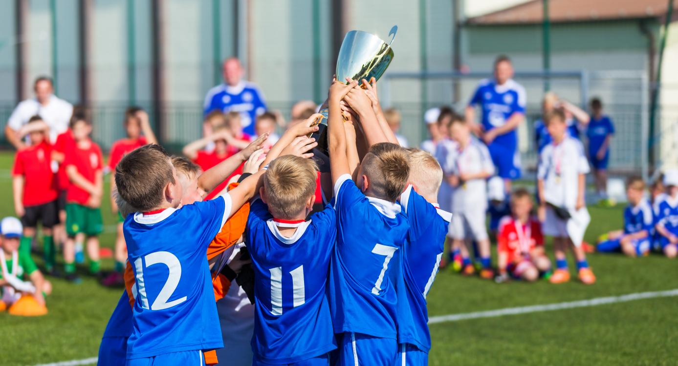 Football team holds up trophy